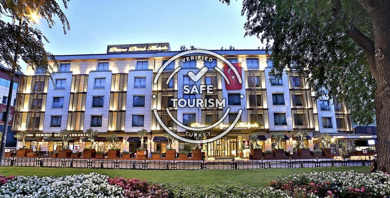 Dosso Dossi Hotels & Spa Downtown Estambul Exterior foto The photo shows a modern hotel building, prominently featuring a well-lit façade. In front of the hotel, there are landscaped gardens with colorful flowers. Overlaying the image is a "Verified Safe Tourism" badge, indicating that the location meets c