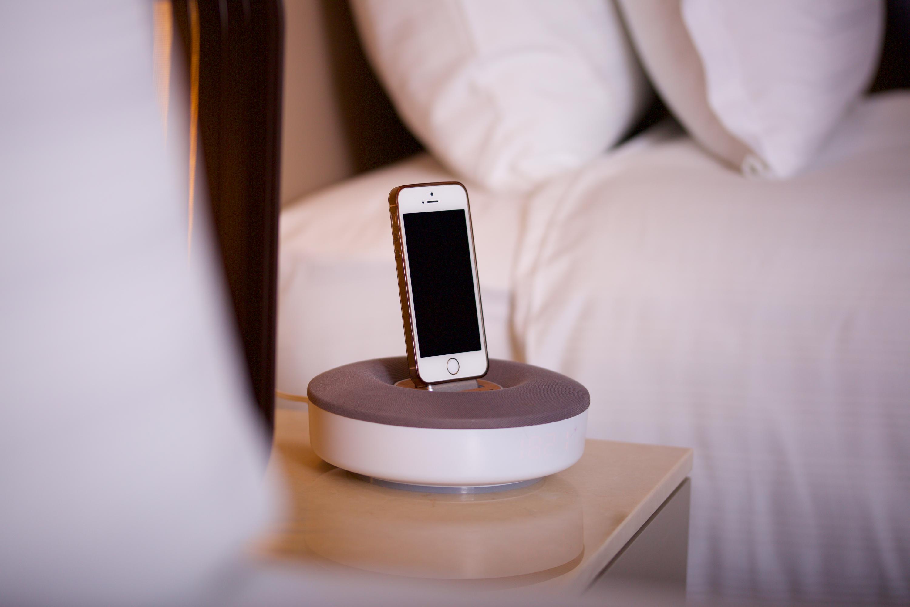 Dosso Dossi Hotels & Spa Downtown Estambul Exterior foto The photo shows a smartphone placed on a charging dock. The dock has a circular base with a gray top and a white bottom. The smartphone is upright in the dock, facing forward, and has a blank screen. There are neatly arranged pillows visible in the b